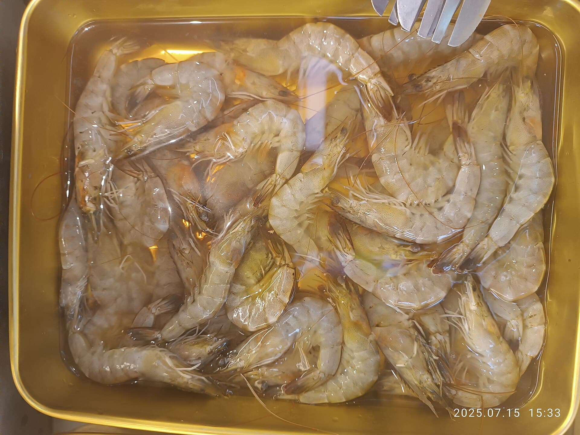 Raw prawns prepared on a tray for cooking